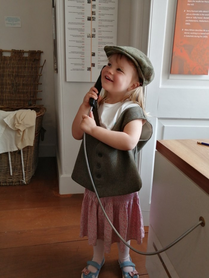 Scottish Borders Textile museum girl dressing up telephone