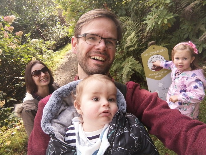 baby smiles forest family