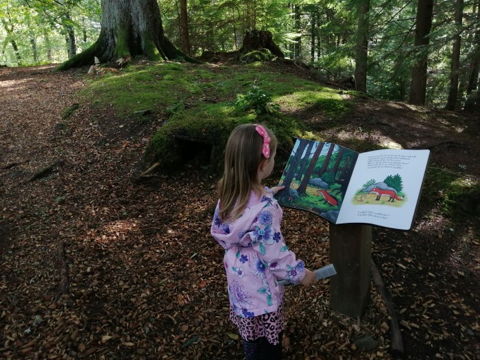 girl in pink forest open book