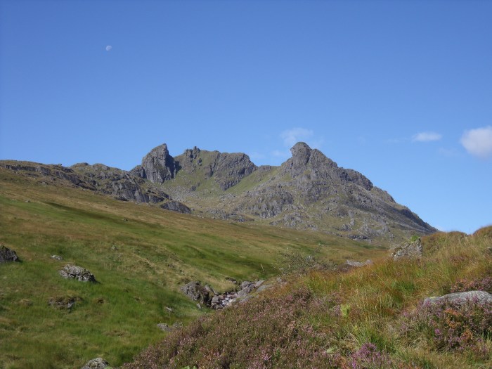 blue skies mountain rugged hill