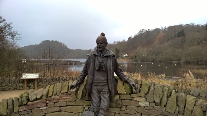 statue open water stone wall