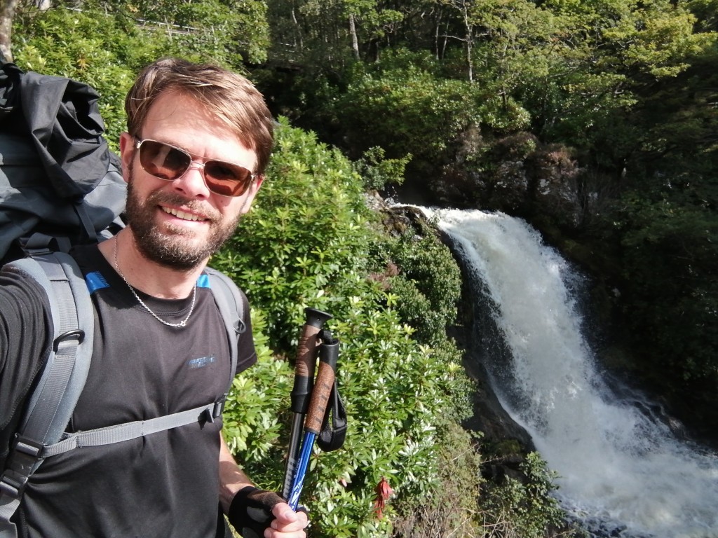 west highland way, scotland, waterfall, hiking gear, guy smiling, sunglasses
