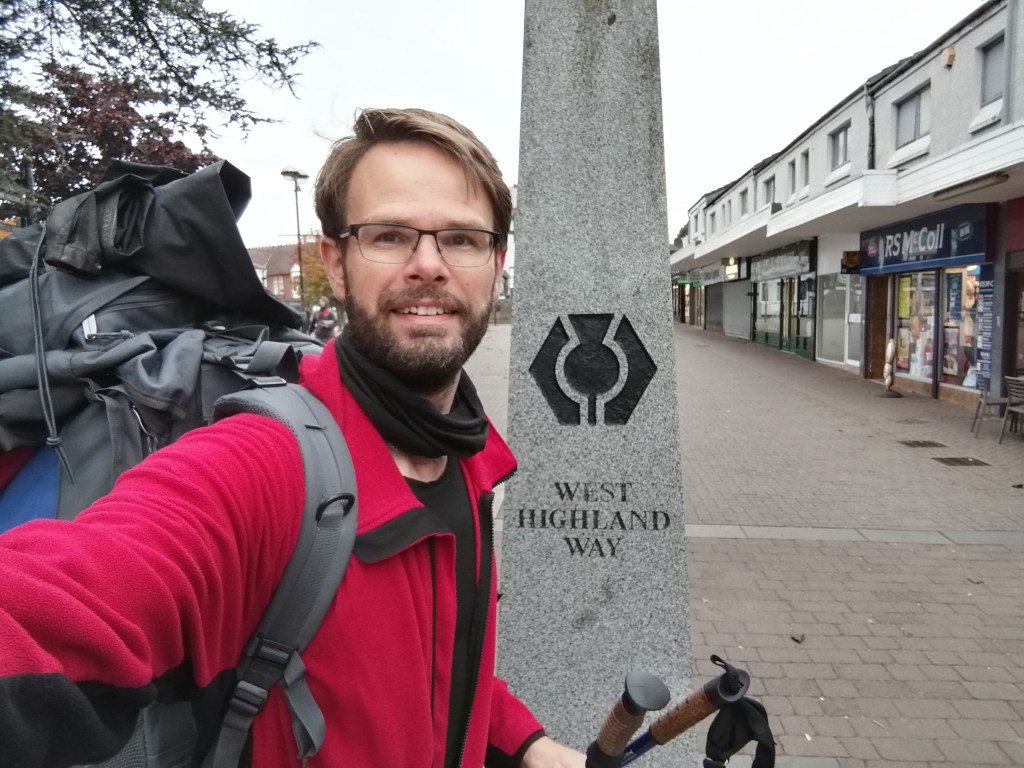 west highland way, milngavie, rucksack, hiking gear, guy smiling, town centre, glasgow, scotland