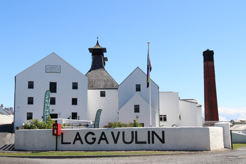 lagavulin distillery, lagavulin, whisky, distillery, blue skies, white building, islay, scotland
