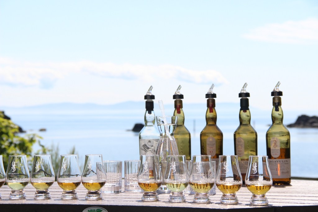 whisky bottles, whisky glass, lagavulin whisky, whisky, whisky tasting, blue skies, islay, scotland