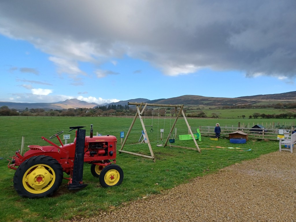 Bellevue farm, red tractor, playground, fields, hills, blue skies, arran